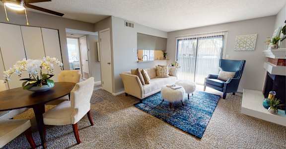 A living room with a dining table and chairs.