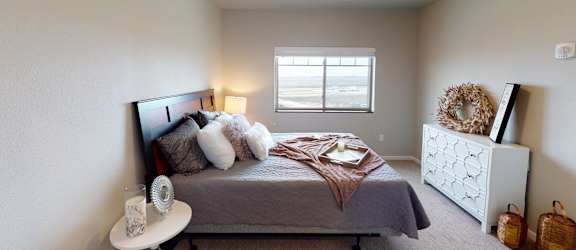 a bedroom with a bed and a window at Upscale Living at the Grand off 45th, Fargo, 58104