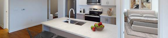 A kitchen with a white island and a bowl of fruit on it.