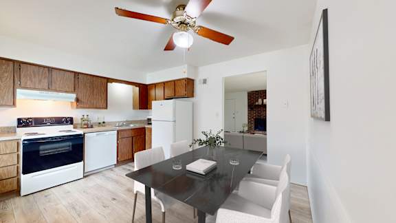 a kitchen and dining room with white appliances and a black dining table