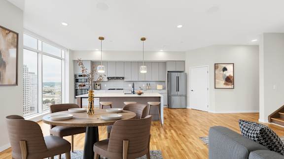 A modern kitchen with a dining table and chairs.
