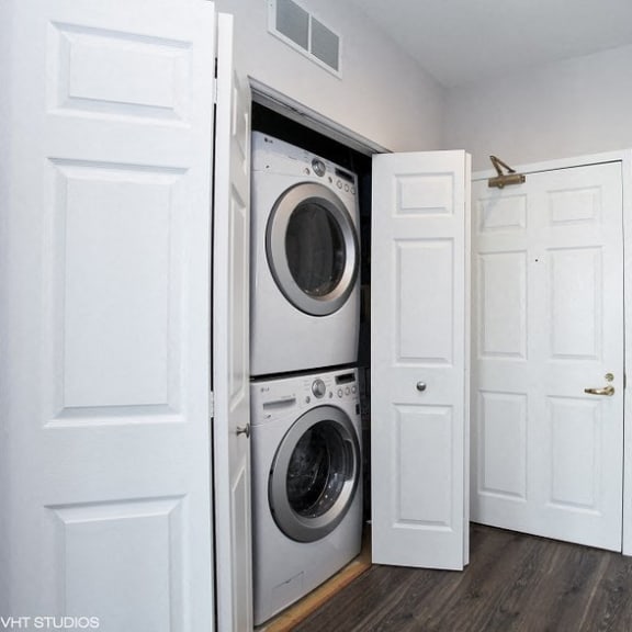 a laundry room with a washer and dryer and a white door