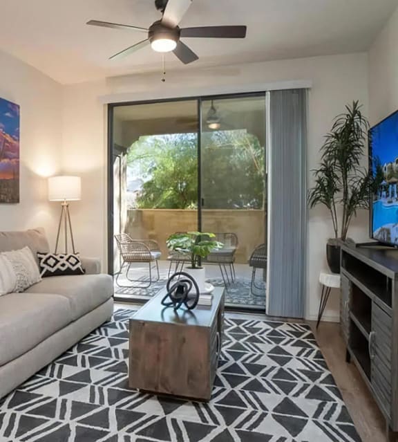 Living Room with Ceiling Fan and Patio Access