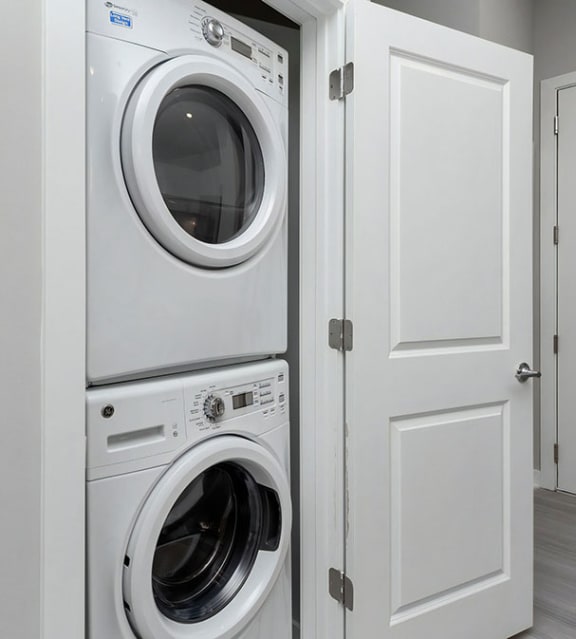 a washing machine and dryer in a white closet