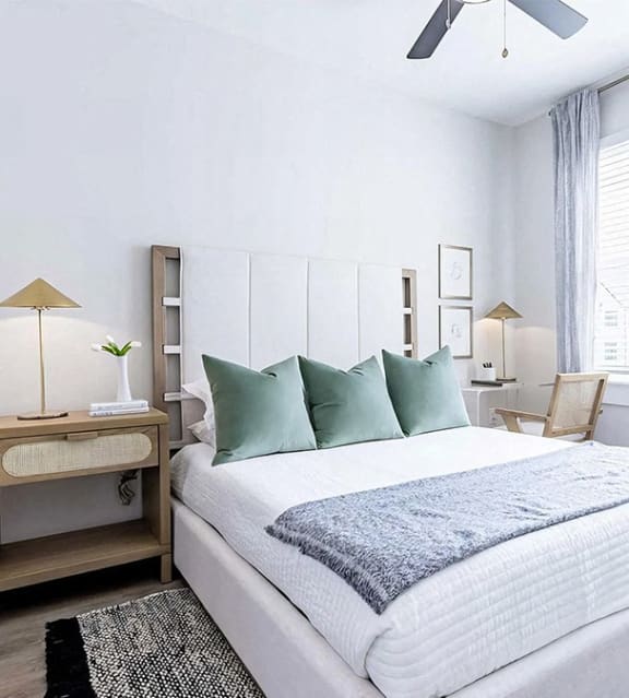 Modern bedroom with ceiling fan and en-suite bathroom at Novel Cary