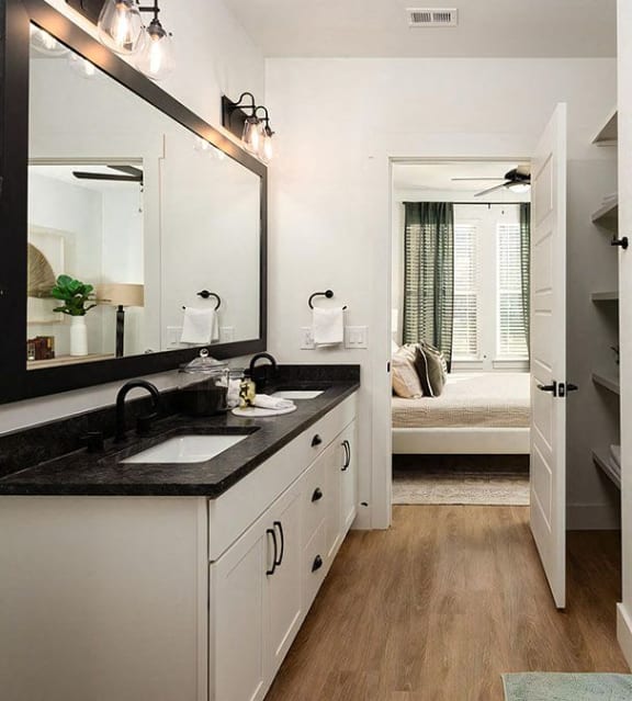 Modern bathroom with walk-in shower and dual vanity sink at Novel Harpeth Heights