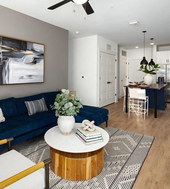 Sophisticated open-concept living room and kitchen with ceiling fan at Novel Harpeth Heights