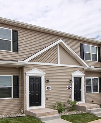 a row of three story houses on a street