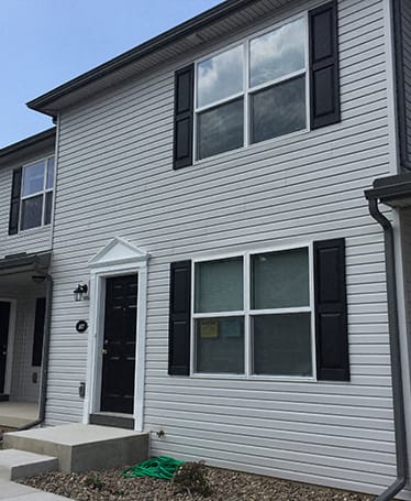 a row of three story houses on a street