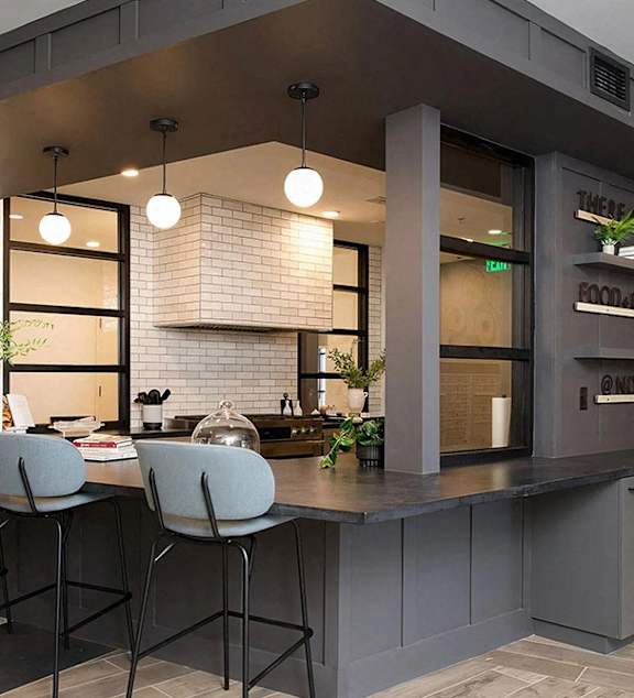 a kitchen with a counter and a table with chairs
