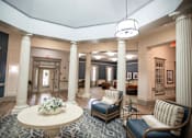 Thumbnail 6 of 31 - A large room with a circular table and chairs.