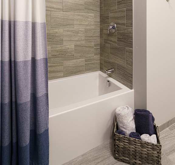 Bathtub with Curtain in Bathroom at Viva Lakeshore, Bridgewater, Massachusetts