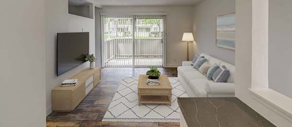 a living room with a white couch and a television