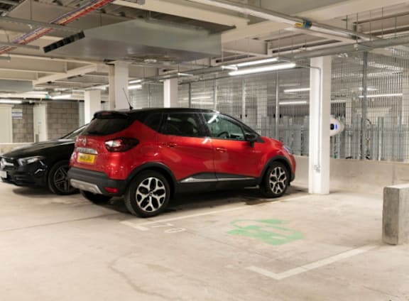 two small cars parked in a parking garage at The Trilogy Apartments, Manchester, M15 4RU