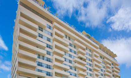 A tall building with a lot of windows and balconies.