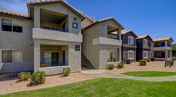 a row of houses with a yard and grass