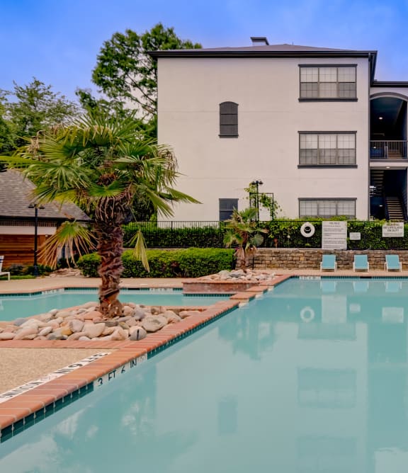 a swimming pool with a building in the background