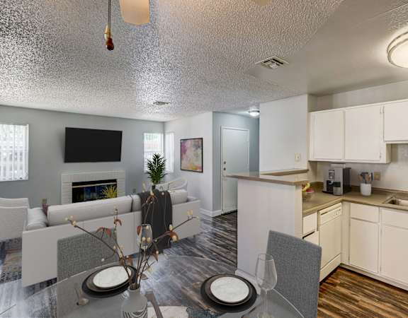 a living room and dining room with a table and chairs and a kitchen