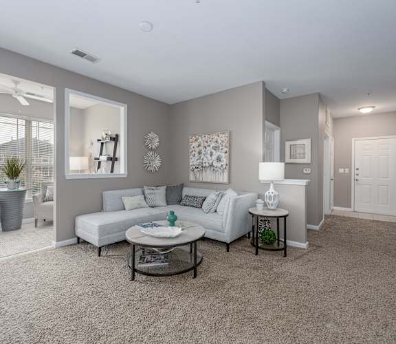 A living room with a white couch and a coffee table.