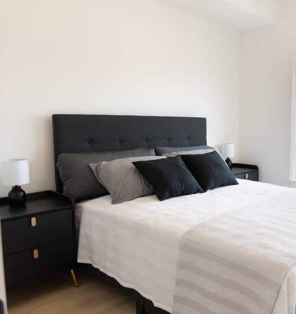 a bedroom with a bed and a large window