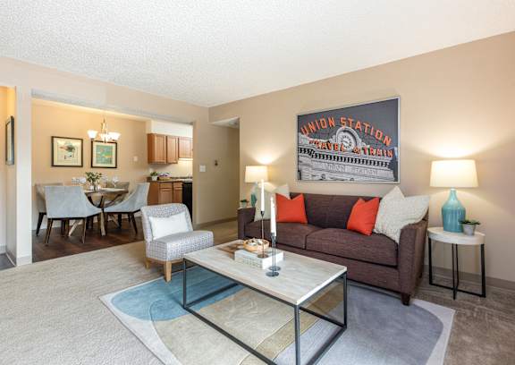 A living room with a couch, chairs, and a coffee table.
