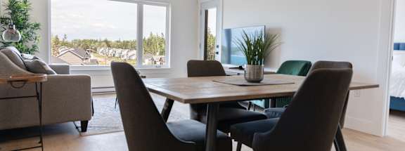 a dining room with a wooden table and chairs