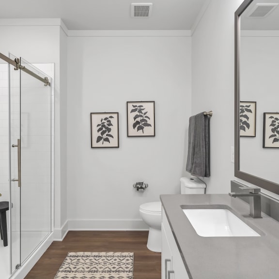 a bathroom with white walls and gray countertops