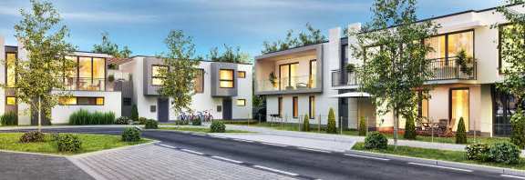 A row of modern houses with trees in front.