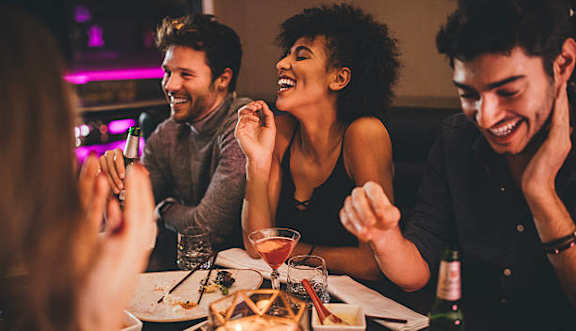 A group of people are enjoying a meal together at a restaurant.