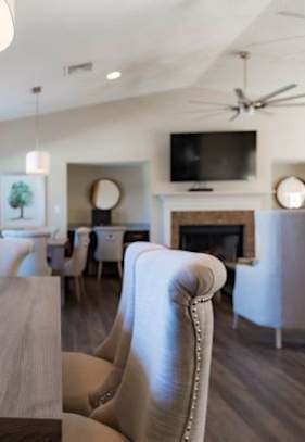 A kitchen with a bar and chairs.