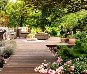 a deck with a swing and a fire pit