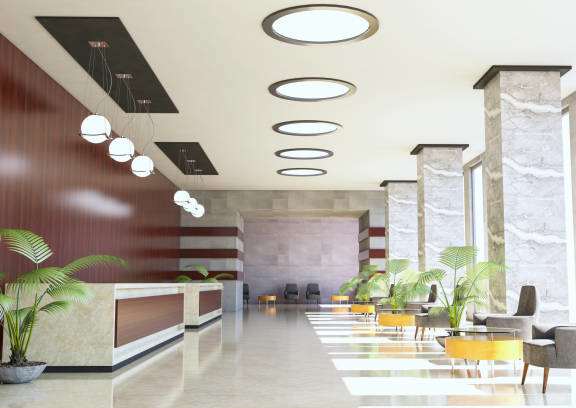 a rendering of a lobby with yellow chairs and a reception desk