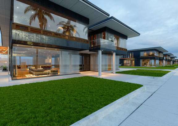 A modern house with a glass wall and a palm tree inside.