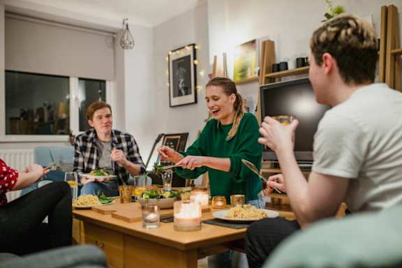 a group of people sitting around a table eating food