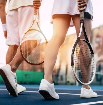 Two tennis players holding rackets on a tennis court.