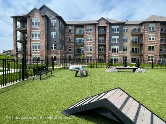 A large apartment complex with a playground in front.