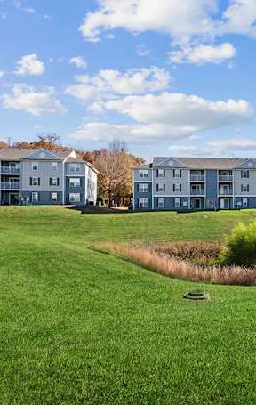 A grassy field with a building in the background.