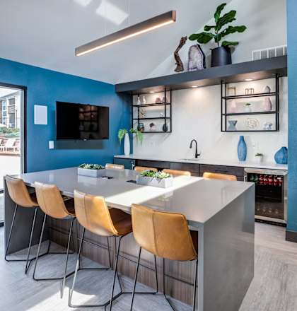 a kitchen with blue walls and a table and chairs
