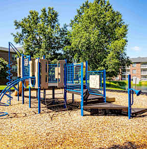 A playground with a blue swing set and a yellow slide at Jamison Park Apartments in North Charleston, SC 29406