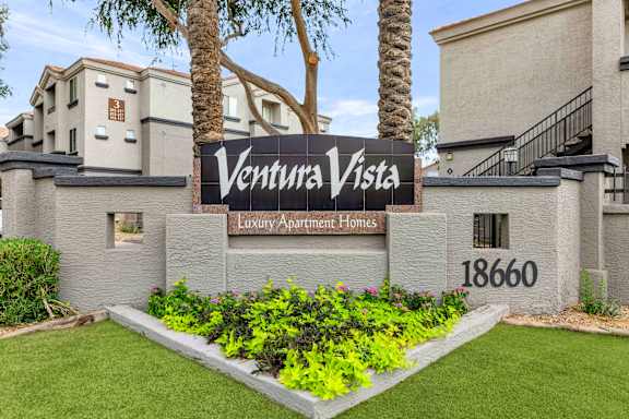 A sign that says Ventura Vista in front of a building.