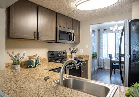 a kitchen with stainless steel appliances and granite counter tops