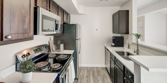our redesigned kitchen is spacious and modern with stainless steel appliances and white countertops