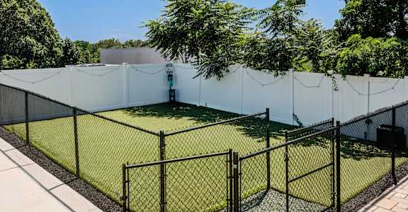 A tennis court surrounded by a fence.