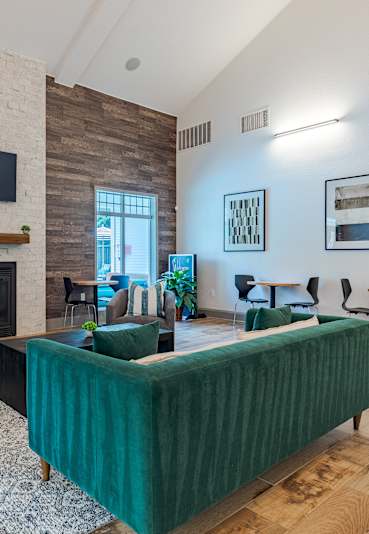 a dining room with a glass table and white chairs at SomerHill Farms Apartments in Gainesville, Virginia