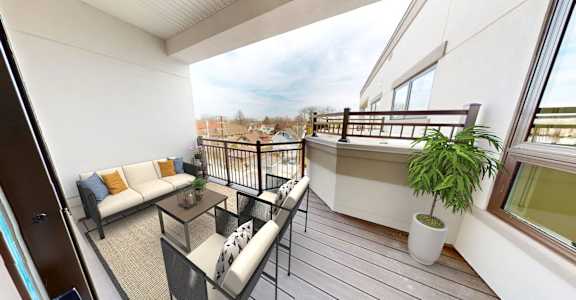 a balcony with a couch and a table