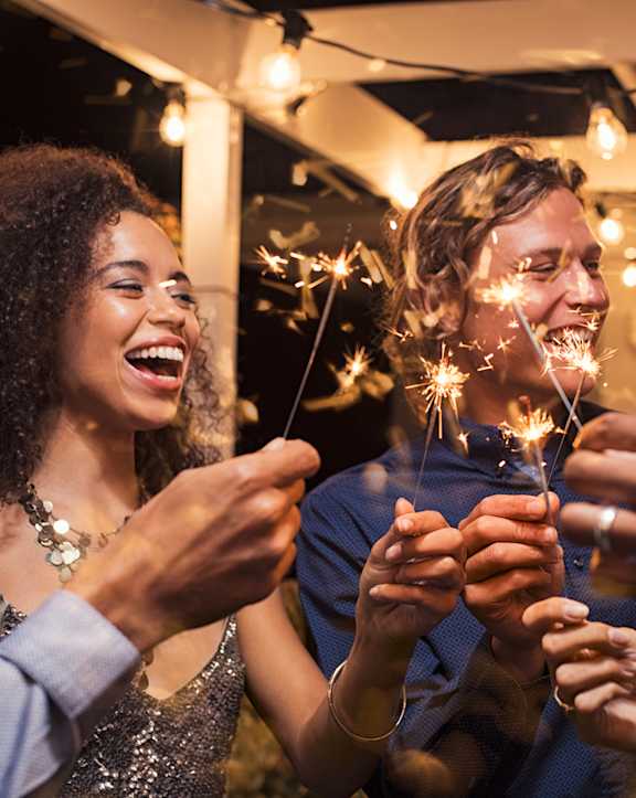 A group of people are celebrating with sparklers.