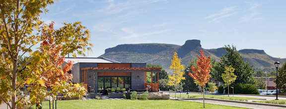A modern building with a mountain in the background.