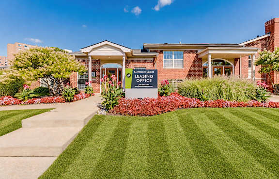Leasing office entrance with flower beds at Canterbury Square Apartments, Troy, MI