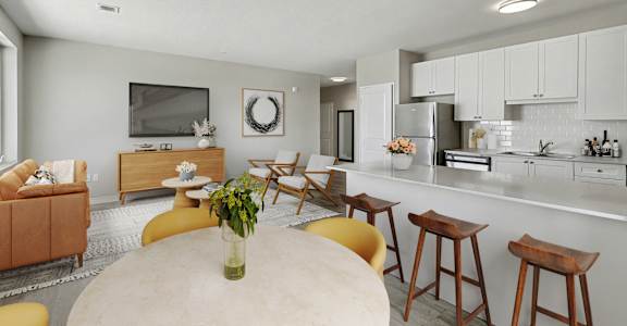 A modern kitchen with a dining table and chairs.