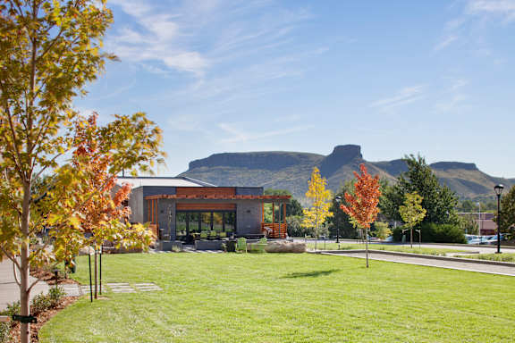A modern building with a mountain in the background.